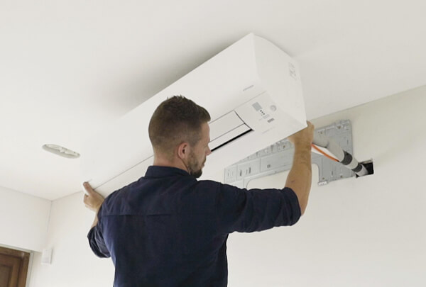 Engineer installing an air conditioning unit